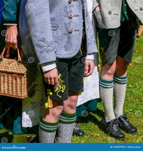 Two Young Men and a Woman Wearing German Traditional Bavarian Clothing, Standing in a Sunny Day ...