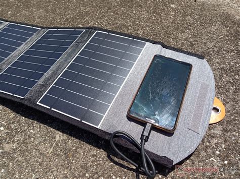 We tried charging our smartphone with a 22 W foldable solar power ...