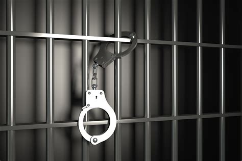 Metal Prison Bars With Handcuffs On Black Background - Carluccio, Leone, Dimon, Doyle & Sacks