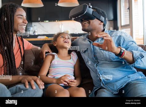 Family playing video games with VR glasses Stock Photo - Alamy