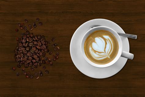 Brown and White Espresso in White Coffee Mug Beside Coffee Beans · Free Stock Photo