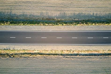 Premium Photo | Aerial view of empty intercity road at sunset. Top view from drone of highway in ...