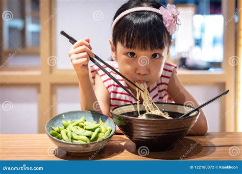 Asian Little Chinese Girl Eating Ramen Noodles Stock Photo - Image of chopsticks, happiness ...