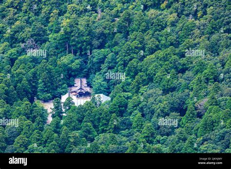 Overhead view of Daisen Temple in clearing surrounded by green forest ...