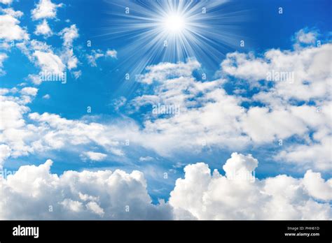 Shining sun and rays on the blue sky Stock Photo - Alamy