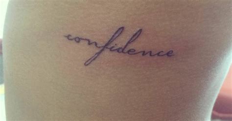 Side tattoo saying "confidence".