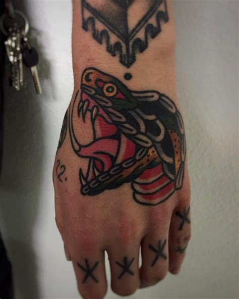 Snake tattoo on the left hand - Tattoogrid.net