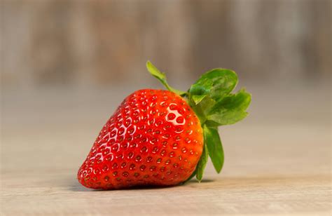 Strawberry Fruit on Brown Wooden Surface · Free Stock Photo