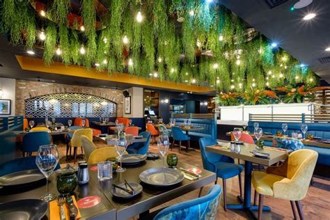 Biophilic restaurant design with ceiling hanging plants Restaurant Lighting, Restaurant Interior ...