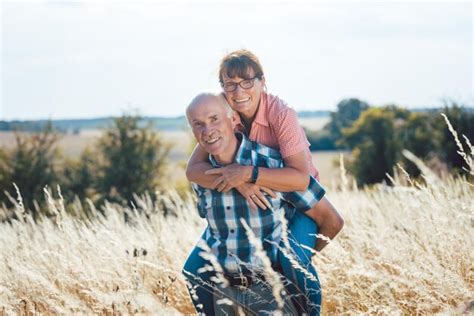 Premium Photo | Portrait of smiling man carrying woman piggyback