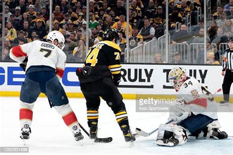 Florida Panthers goalie Alex Lyon knocks the puck away from Boston ...