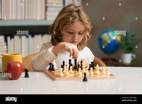 Child boy developing chess strategy, playing board game. Intelligent and smart kids. Games good ...