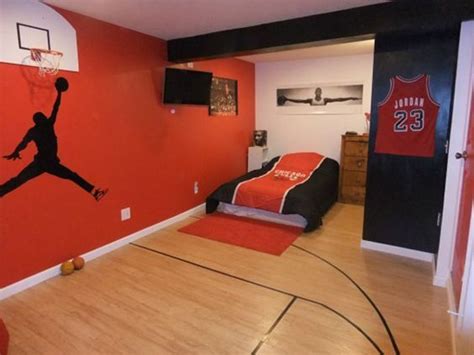 a bedroom decorated in red and black with a basketball painted on the wall