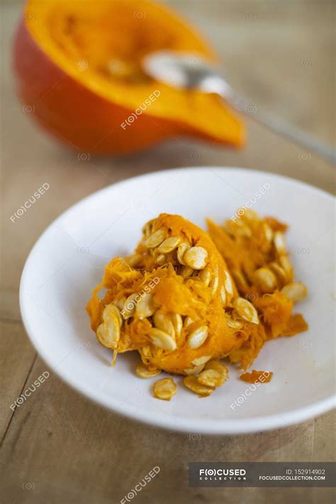 Seeds and fruit pulp from a Hokkaido pumpkin on white plate — vital, elements - Stock Photo ...