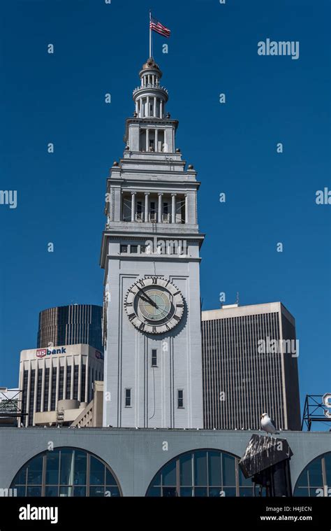 San Francisco Ferry Building clock tower in skyline facing water ...