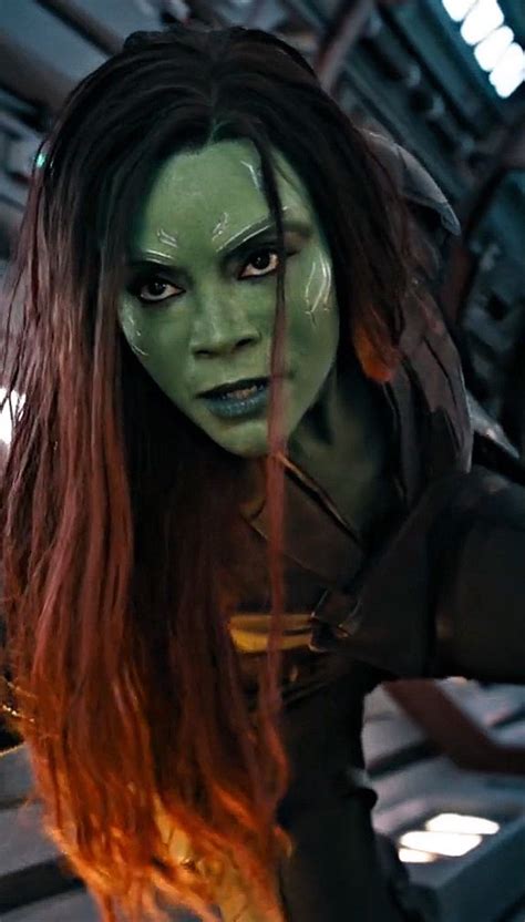 a woman with long hair and green makeup in a scene from the film, guardians