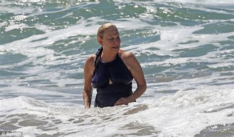 Bette Midler takes a dip in the Pacific after hitting the beach in a striking blue swimsuit ...