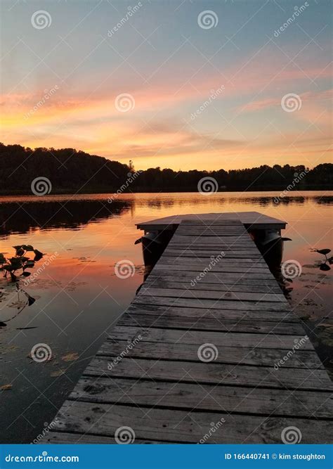 Dock at sunset stock image. Image of sunset, water, dock - 166440741