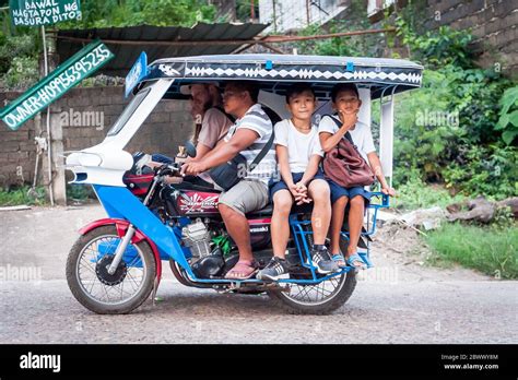 The famous filipino tricycle or tuk tuk (sometimes called rickshaw) makes its way along the busy ...