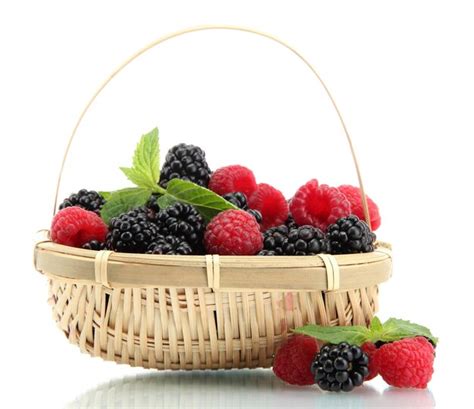 Premium Photo | Beautiful berries with leaves in basket isolated on white