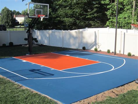 an outdoor basketball court in the backyard