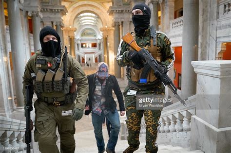 Gun rights activists carrying semi-automatic firearms walk through the ...