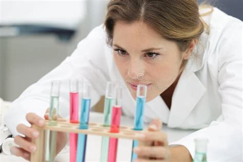 Young Chemistry Teacher in School Laboratory Workplace Looking at Test-tube Stock Photo - Image ...