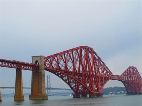 a large red bridge spanning across a body of water