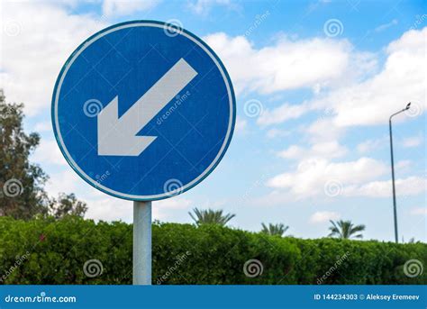 Round Blue Road Sign with White Diagonal Warning Arrow. Horizontal Frame Stock Image - Image of ...