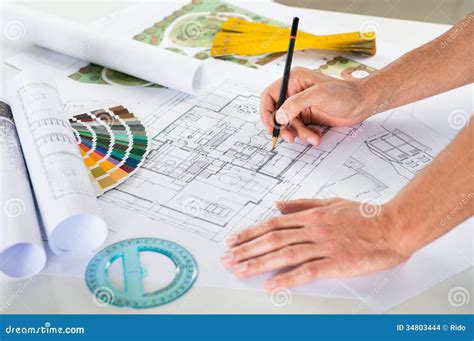 Draftsman Drawing Plan On Blueprint Stock Photo - Image: 34803444