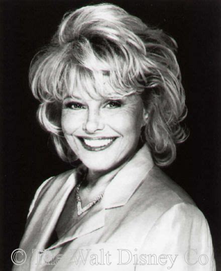 an old black and white photo of a woman with blonde hair smiling at the camera