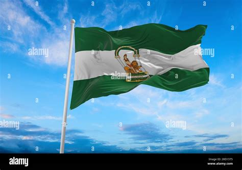 flag of Ibero-Romance peoples Andalusians at cloudy sky background, panoramic view. flag ...