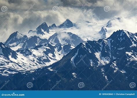 Jagged Peaks of the Olympic Mountains Covered by Snow and Clouds Stock Photo - Image of olympic ...