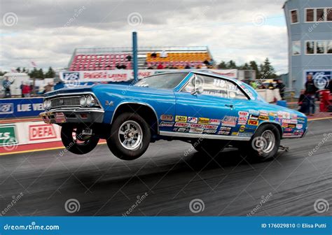 A Drag Race Car Speeding Up in Quarter Mile Race with Nitro Burning ...