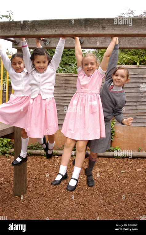 girls on monkey bars in school uniforms Stock Photo - Alamy