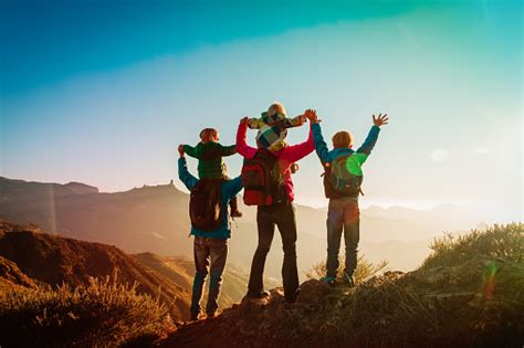 Happy Family Travel In Mountains At Sunset Stock Photo - Download Image Now - iStock