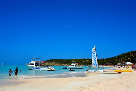 Couple Wading into Water at Dickenson Bay in St. John’s, Antigua ...