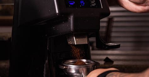 A Barista Using a Coffee Grinder · Free Stock Photo