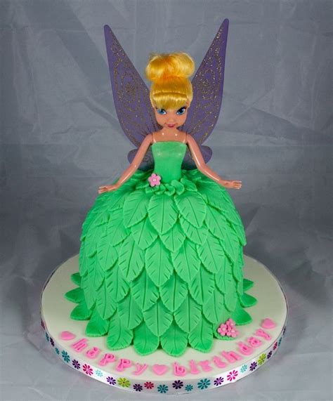 a green cake with a fairy on top