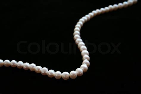 Pearls necklace on the black velvet background | Stock Photo | Colourbox