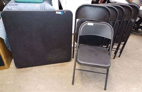 Black card table, six black folding chairs. - Mark Van Hook, Auctioneer