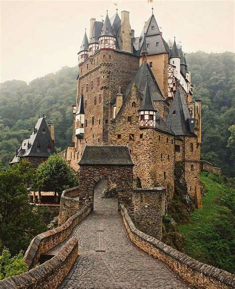 an old castle with turrets and towers on the top of it's side walk