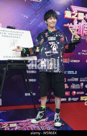 Chinese singer and actor Wowkie Zhang, also known as Da Zhang Wei, poses with his trophy after ...