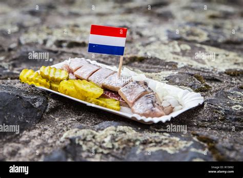 Amsterdam / The Netherlands - December 16 2018: traditional Dutch street food - herring with ...