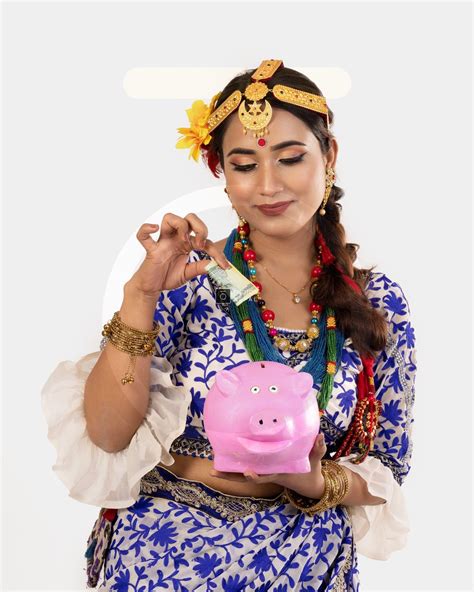 Nepali Girl Saving Money: Putting Money into a Piggy Bank - Photos Nepal