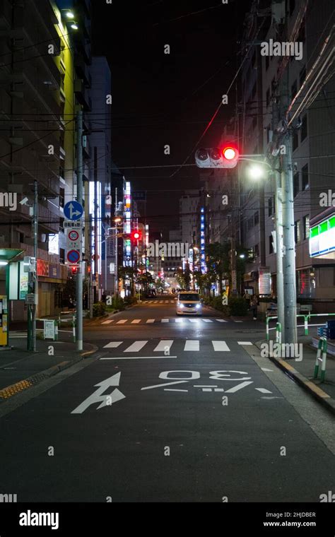 Night view of narrow alley in Ikebukuro, Toshima, Tokyo with traffic light and street signs ...