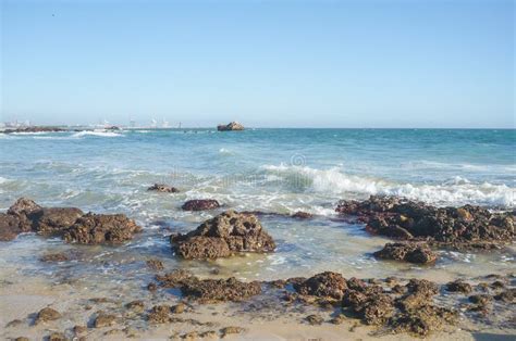 Nelson Mandela Bay Beach with Rocks Looking Towards Harbour Cranes ...