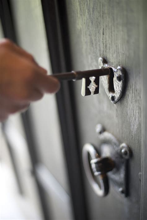 Man inserting a key in a door lock-7241 | Stockarch Free Stock Photos