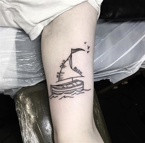 Small sailing boat tattoo on the arm - Tattoogrid.net