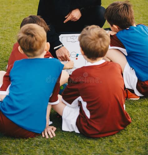 Coach Coaching Preschool Soccer Boy. Youth Coach Explaining Tactics ...